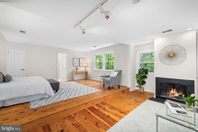 1517 Snughill Ct, Vienna, VA 22182 - bedroom featuring rail lighting, wood-type flooring, a fireplace with flush hearth, baseboards, and recessed lighting