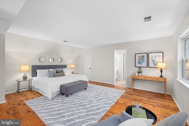 1517 Snughill Ct, Vienna, VA 22182 - bedroom with wood-type flooring, baseboards, vaulted ceiling, and ensuite bathroom