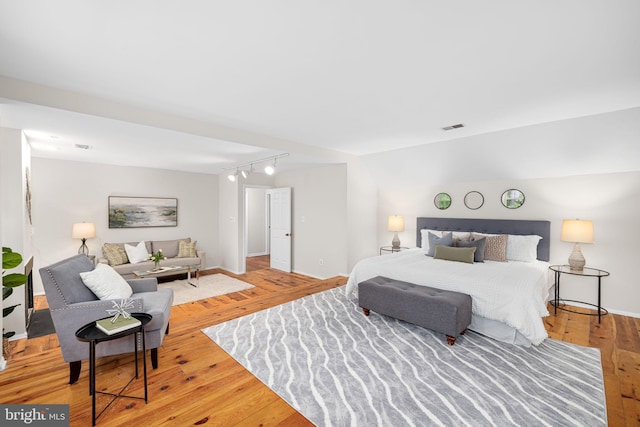 1517 Snughill Ct, Vienna, VA 22182 - bedroom with rail lighting, light wood-type flooring, and baseboards