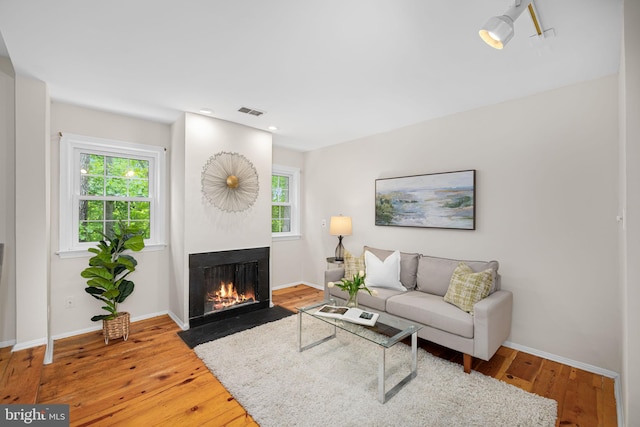 1517 Snughill Ct, Vienna, VA 22182 - living room featuring a fireplace with flush hearth, wood-type flooring, baseboards, and recessed lighting