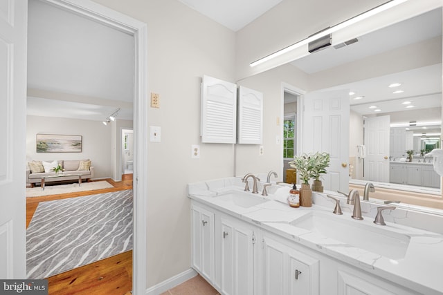 1517 Snughill Ct, Vienna, VA 22182 - bathroom with double vanity, baseboards, recessed lighting, and wood finished floors