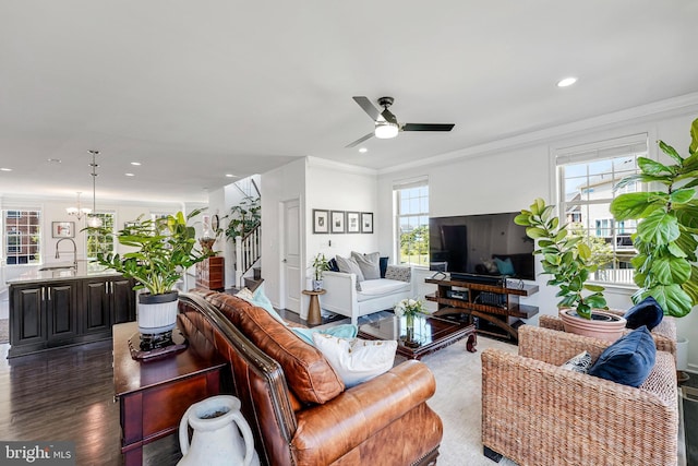 living area with stairs, ceiling fan, recessed lighting, crown molding, and dark wood-type flooring