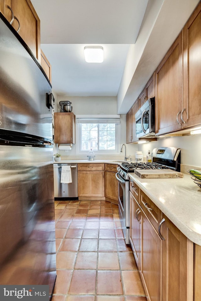 1608 Preston Rd, Alexandria, VA 22302 - kitchen with a sink, appliances with stainless steel finishes, brown cabinets, light countertops, and light tile patterned floors