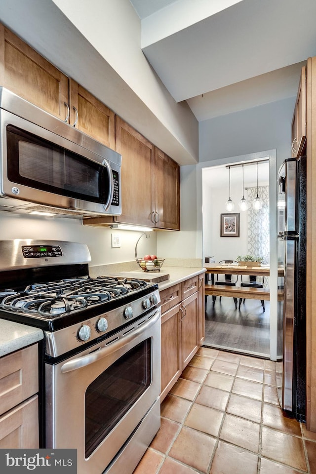 1608 Preston Rd, Alexandria, VA 22302 - kitchen with light tile patterned floors, light countertops, decorative light fixtures, and appliances with stainless steel finishes