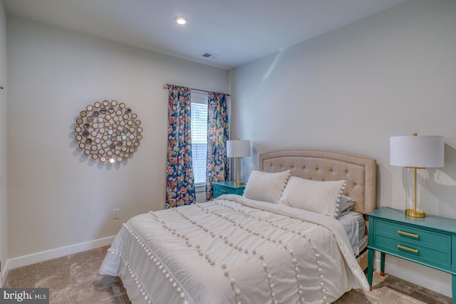 bedroom with visible vents, baseboards, and carpet