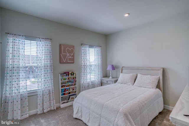 carpeted bedroom featuring baseboards