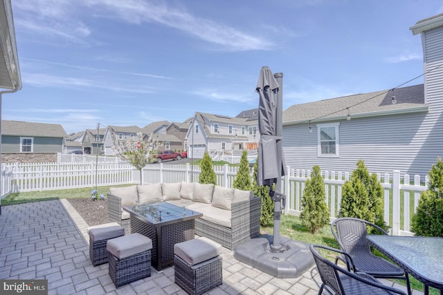 view of patio / terrace with a fenced backyard, a residential view, outdoor dining space, and an outdoor hangout area