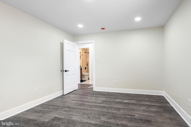 unfurnished room featuring baseboards, dark wood-type flooring, and recessed lighting