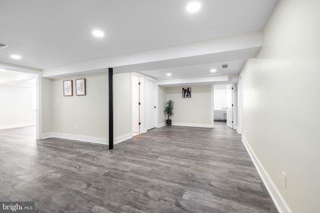 finished basement with recessed lighting, dark wood finished floors, visible vents, and baseboards