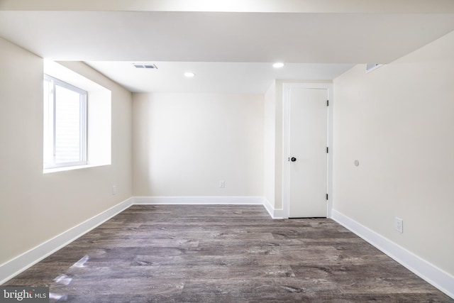 below grade area with baseboards, wood finished floors, visible vents, and recessed lighting