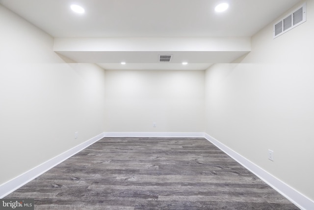 finished basement with recessed lighting, visible vents, and dark wood-type flooring