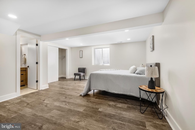 bedroom with baseboards, wood finished floors, and recessed lighting