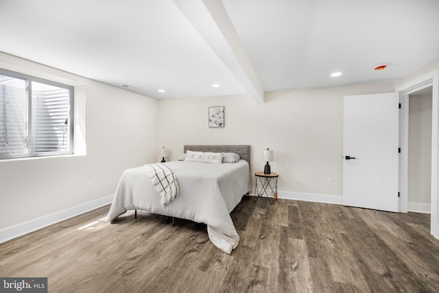bedroom featuring baseboards, wood finished floors, and recessed lighting