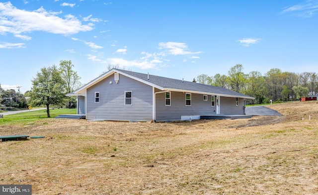 back of property with a lawn