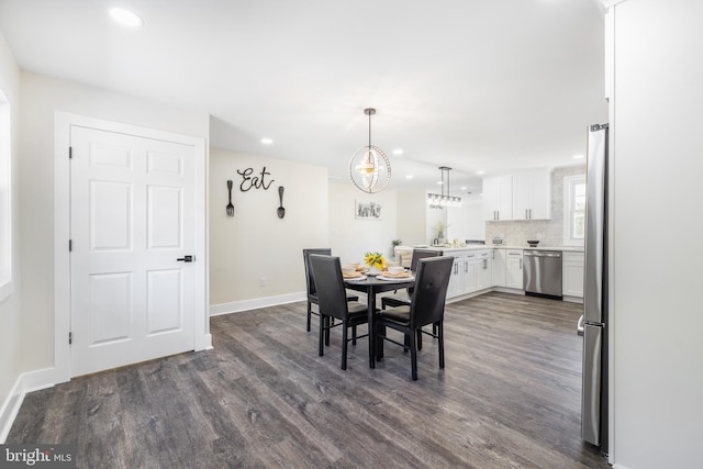 dining room with recessed lighting, a chandelier, baseboards, and dark wood-style flooring