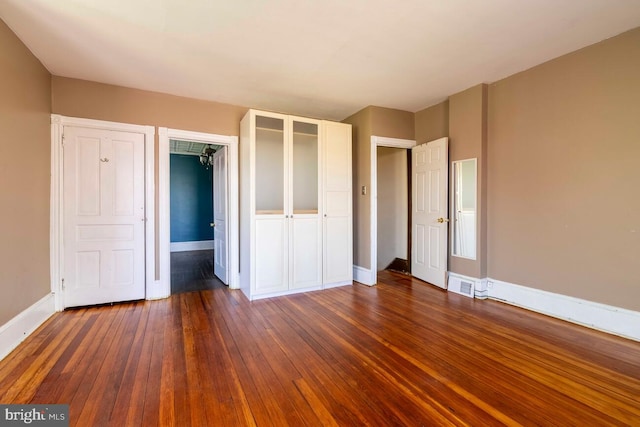 610 Washington Ln, Jenkintown, PA 19046 - unfurnished bedroom featuring baseboards, visible vents, dark wood-type flooring, and a closet