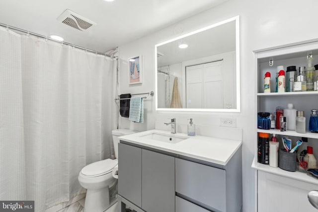 full bathroom featuring vanity, toilet, and visible vents