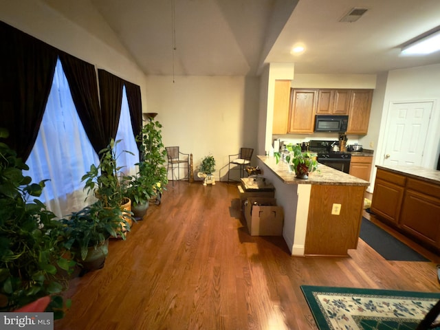 11258 Wildmeadows St, Waldorf, MD 20601 - kitchen with black appliances, dark wood-type flooring, a peninsula, recessed lighting, and vaulted ceiling