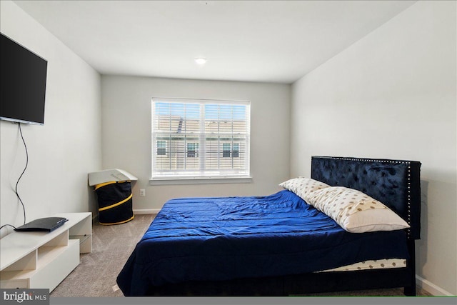 carpeted bedroom featuring baseboards