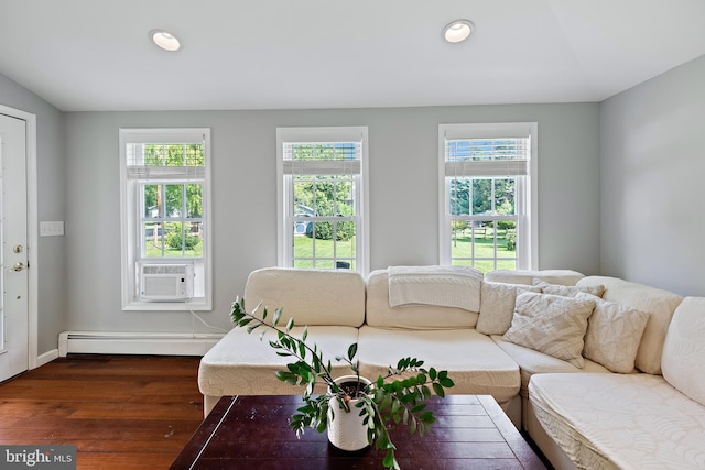 living area featuring recessed lighting, a baseboard heating unit, plenty of natural light, and dark wood-type flooring