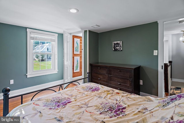 bedroom with recessed lighting, baseboards, and wood finished floors