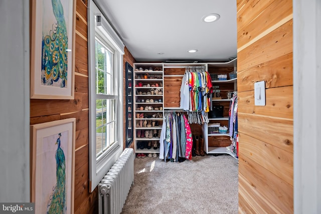 walk in closet featuring carpet and radiator heating unit