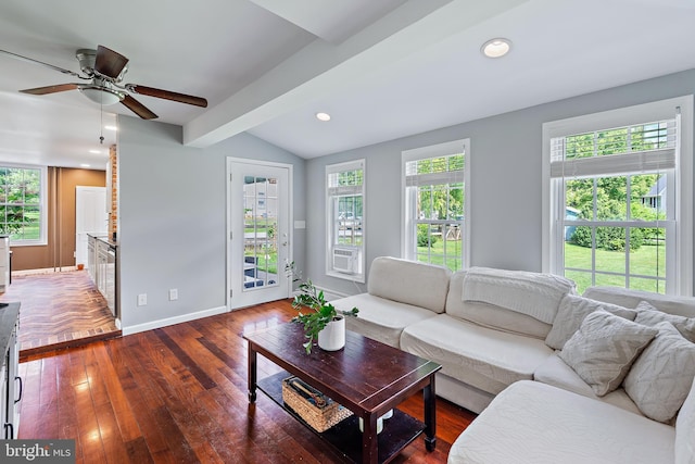 living area featuring ceiling fan, vaulted ceiling with beams, plenty of natural light, and wood finished floors