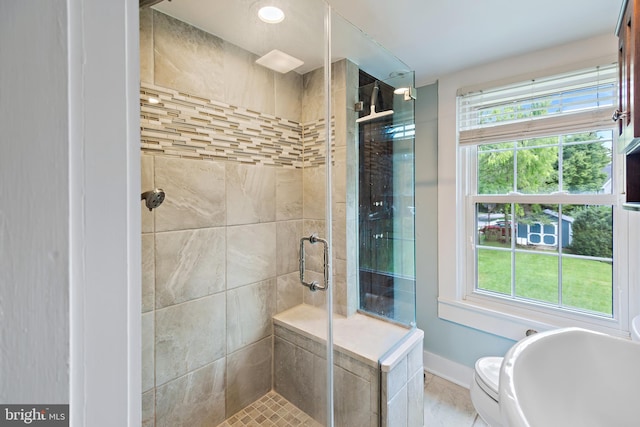 bathroom featuring baseboards and a stall shower