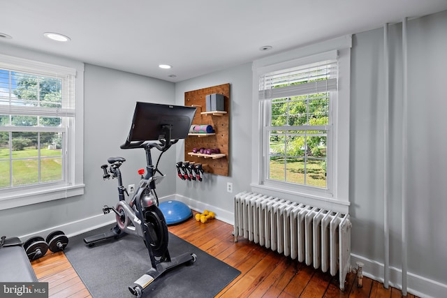 workout room with radiator, recessed lighting, and hardwood / wood-style floors