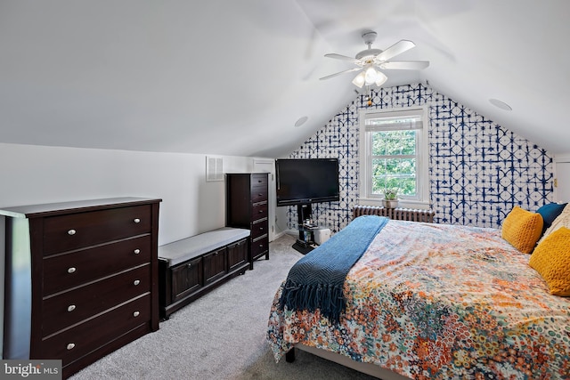 bedroom featuring visible vents, radiator, lofted ceiling, light carpet, and a ceiling fan