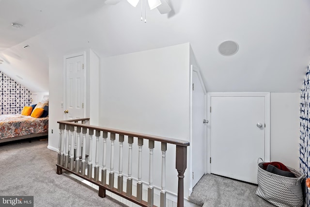 interior space featuring carpet, ceiling fan, and lofted ceiling