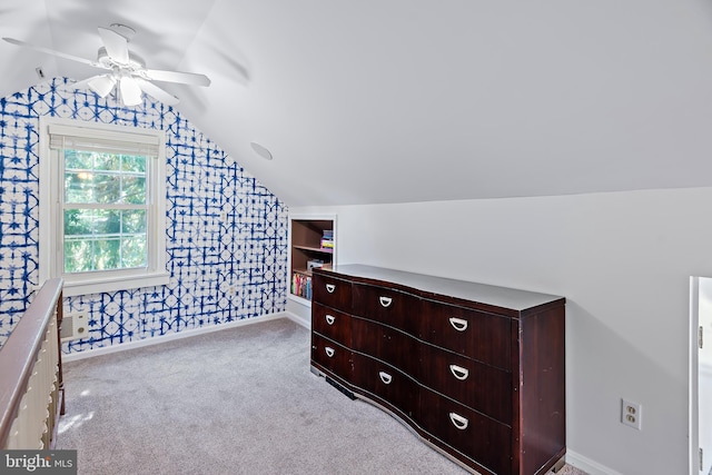 carpeted bedroom with baseboards, a ceiling fan, wallpapered walls, and lofted ceiling
