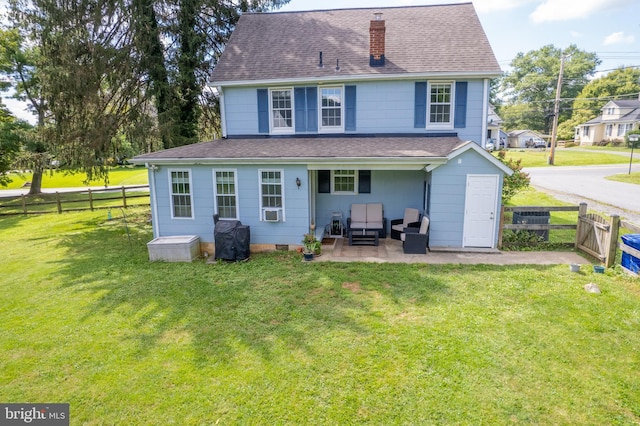 back of property featuring a fenced backyard, a shingled roof, and a yard