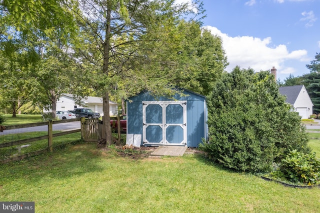 view of shed featuring fence