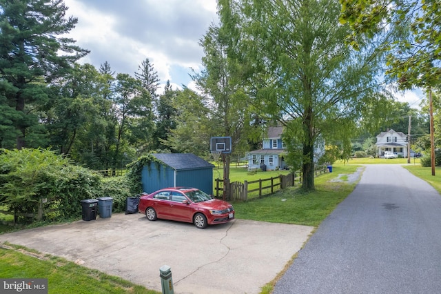 exterior space with fence and a storage shed