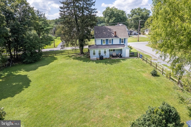 exterior space with a lawn, driveway, and fence private yard