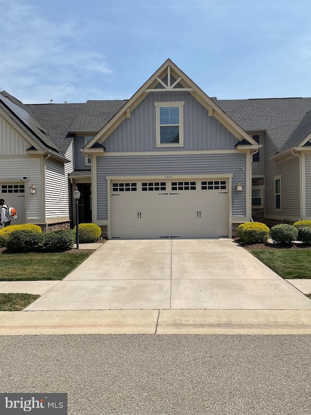 7805 Wistar Woods Pl, Henrico, VA 23228 - craftsman-style home with stone siding, board and batten siding, concrete driveway, and a garage