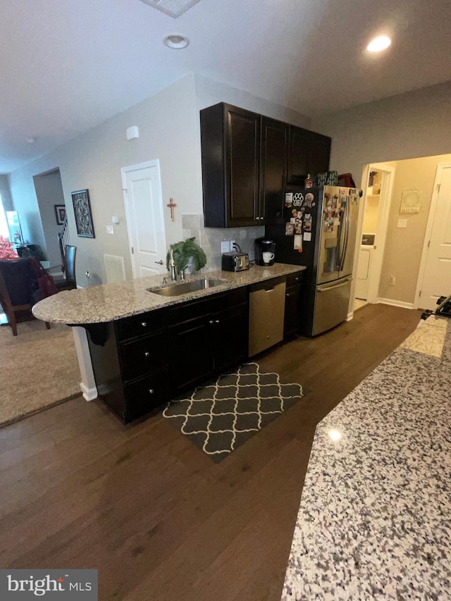 7805 Wistar Woods Pl, Henrico, VA 23228 - kitchen featuring light stone countertops, a sink, dark wood-style flooring, stainless steel appliances, and a peninsula