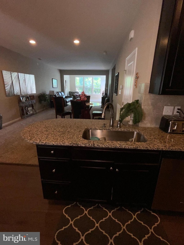 7805 Wistar Woods Pl, Henrico, VA 23228 - kitchen featuring open floor plan, light stone countertops, recessed lighting, and a sink