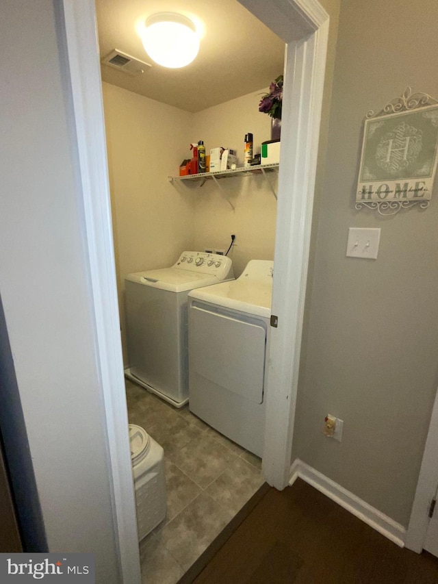 7805 Wistar Woods Pl, Henrico, VA 23228 - clothes washing area with tile patterned flooring, separate washer and dryer, visible vents, and laundry area