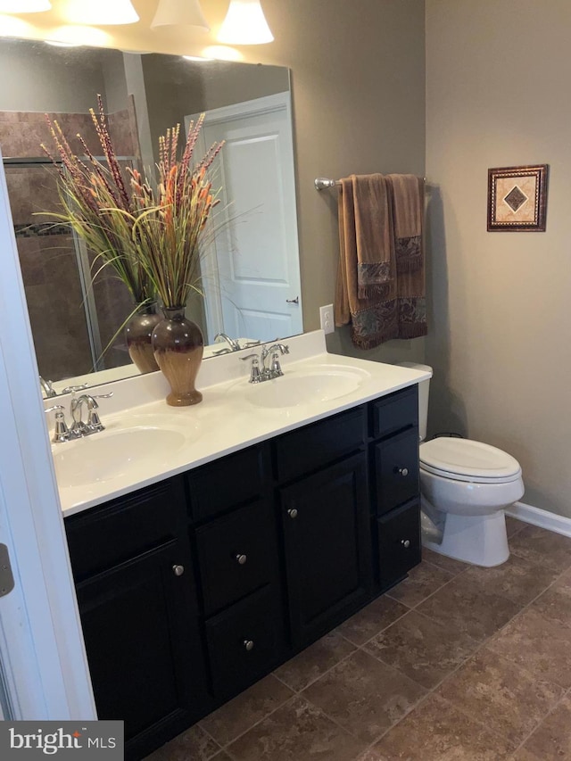 7805 Wistar Woods Pl, Henrico, VA 23228 - bathroom with baseboards, toilet, double vanity, and a sink