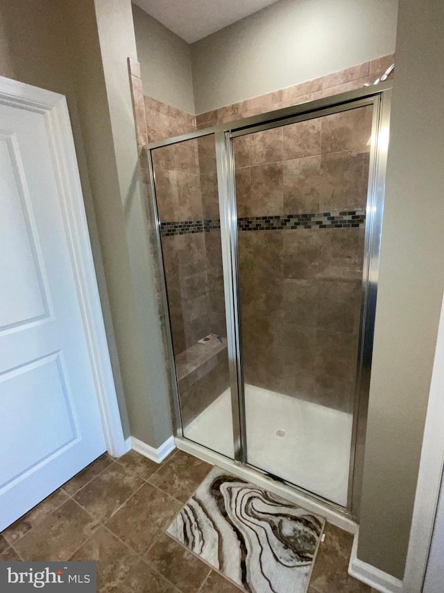 7805 Wistar Woods Pl, Henrico, VA 23228 - bathroom featuring baseboards, a stall shower, and tile patterned flooring