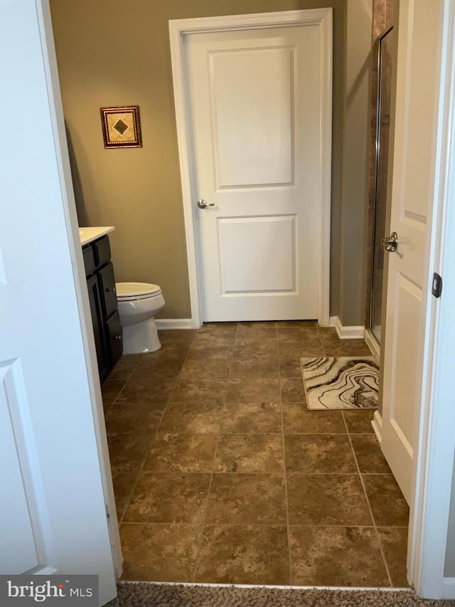 7805 Wistar Woods Pl, Henrico, VA 23228 - bathroom with toilet, vanity, a stall shower, and baseboards