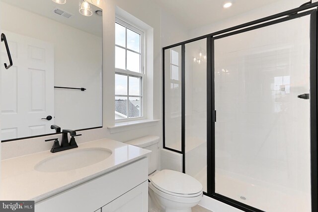 full bath featuring toilet, vanity, visible vents, and a stall shower