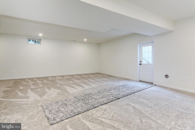 basement featuring light carpet, baseboards, and recessed lighting