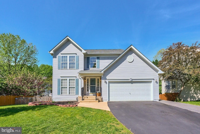 traditional-style house featuring fence, driveway, a front lawn, and a garage