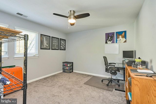 home office featuring carpet flooring, a ceiling fan, baseboards, and visible vents