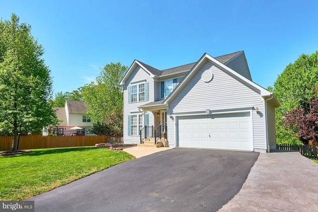 view of front of home with fence, an attached garage, driveway, and a front lawn
