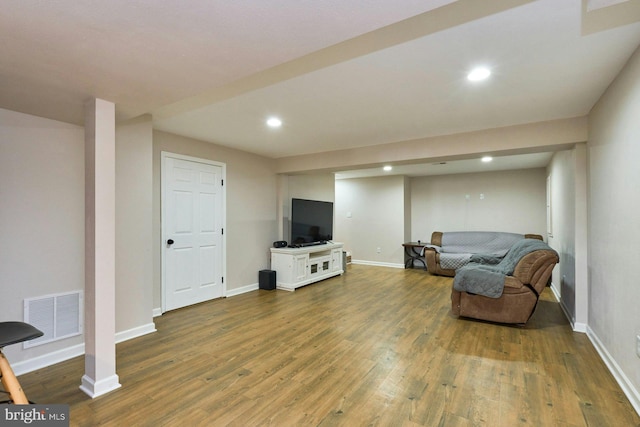 living area featuring recessed lighting, wood finished floors, and visible vents