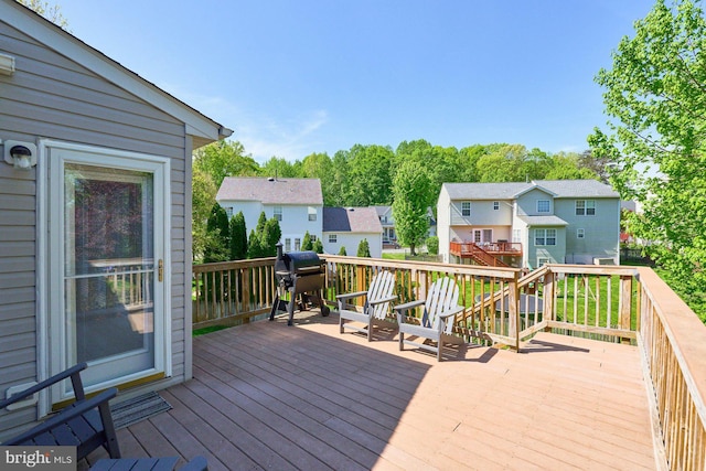 deck featuring grilling area and a residential view